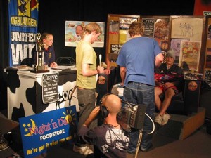 The presenter audition night. Sasha is behind the Cow desk. Matt, in tan, Cam in blue. Tony on the ground getting a shot ready to come back to.